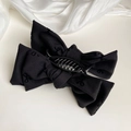 Elegant black bow hair claw clip with vintage fabric pattern on white silk background - Black