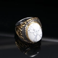 Macro shot of punk style steel ring with white turquoise stone and flame carvings - Silver Gold White Turquoise
