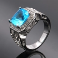 Detailed macro view of silver titanium ring with rectangular blue gem and side zircon stones - Size 7 / Steel Base Aqua Blue Gemstone