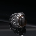 Macro shot of vintage titanium steel ring featuring flame patterns and a large brown gemstone - US 7 / Steel Tiger Eye