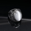 Detail of vintage punk ring featuring a white cat eye stone and flame relief carving - Silver White Cat's Eye