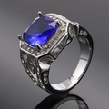 Macro shot of silver ring featuring a large cushion-cut blue stone and zircon accents - Size 7 / Steel Blue Sapphire
