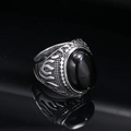 Detail view of vintage punk ring featuring a black oval gemstone and flame carvings - Steel Color Black Gemstone