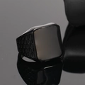 Macro shot of black titanium signet ring with square face and honeycomb side texture - Black