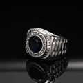 Detail view of men's titanium ring with blue center stone and diamond-paved border - US 7 / Steel Color Dark Blue Zirconia