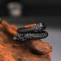 Detailed close-up of vintage black dragon scale ring on natural wood background - US 7 / Black