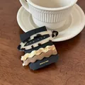 Detailed view of three acetate hair clips featuring oval and wave shapes on a card - Set of 3 / Light Tortoiseshell