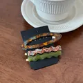 Three-piece acetate hair clip set featuring tortoiseshell and marble patterns on wood - Set of 3 / Dark Tortoiseshell