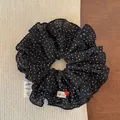 Detailed view of polka dot scrunchie with handmade label and red heart button decor - Black Polka Dot Scrunchie
