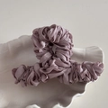 Close-up of Large mauve fabric-wrapped hair claw clip with pleated texture on shell tray - Dust Rose