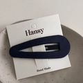 Close-up of a blue fabric teardrop hair clip on a white handmade display card - Navy Blue Snap Clip