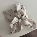 Detail view of cream floral satin hair scrunchie with elegant black flower pattern - Beige Print Ribbon Scrunchie
