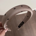 Close-up of champagne satin headband with black floral print and thick sponge padding - Coffee Print Padded Headband
