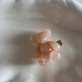 Detail of a pink translucent resin bear hair clip with a gold metal duckbill fastener - Pink