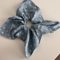 Detail of floral scrunchie in blue-grey fabric with delicate white flower patterns - Bow Scrunchie / Light Blue