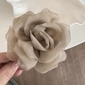 Close-up of lightweight chiffon rose hair claw featuring delicate layered fabric petals - Brown