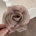 Detail of dusty rose organza rose hair claw showing delicate layers of translucent petals - Gradient Pink