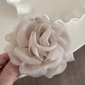 Close-up of elegant beige organza rose hair claw showing layered fabric petals and texture - Apricot