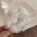 Detalle macro de pinza de pelo rosa de organza blanca con capas de tela traslúcida y elegante - Blanco Roto