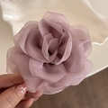 Close-up of layered light purple chiffon rose hair claw clip with delicate fabric petals - Dust Rose