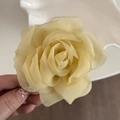 Close-up of lightweight champagne organza rose hair claw with delicate layered petals - Yellow