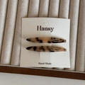 Detail of two tortoise shell acetate hair clips with gold Barrette La France engraving - Light Tortoiseshell