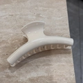 Detailed top view of a minimalist cream-colored hair claw clip on a stone surface - Cream Solid - Thick Line