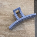 Detail of light blue hair claw clip with golden metal spring on marble surface - Hollow Bar Style (Light Blue)