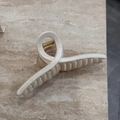 Detail of cream matte hair claw clip with golden spring on marble texture background - Cream Solid - Hanger Shape