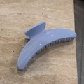 Detailed view of the glossy light blue hair claw clip with sturdy interlocking teeth - Crescent Style (Light Blue)