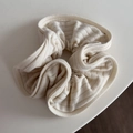 Close-up detail of beige striped knitted fabric texture on soft elastic scrunchie - Striped Knit Scrunchie - Beige