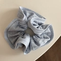 Close-up of light blue ribbed knit scrunchie showing detailed fabric texture and ruffles - Striped Knit Scrunchie - Blue