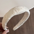 Close-up of creamy white fabric headband with elegant floral embroidery and thick sponge padding - Neo-Chinese Embroidery Cream Headband