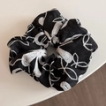 Detail of black fabric scrunchie with white floral embroidery and fine thread texture - Neo-Chinese Embroidery Black Scrunchie
