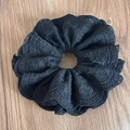 Macro shot of black lace scrunchie with detailed embroidery on a wooden surface - Multi-layer Lace Black