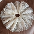 Close-up detail of white lace mesh scrunchie with delicate floral embroidery on wood surface - Tulle Leaf Lace
