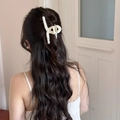 Detailed view of a cream lace-textured hair claw clip holding a half-up hairstyle - Lace Wrapped Criss-cross Claw Clip