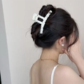 Detailed view of white crochet lace hair claw clip worn on a female model for styling - Lace Wrapped Bar Claw Clip