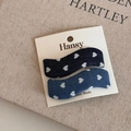Detail of wavy denim hair clips with white heart patterns on display card - Wave Style / Denim Blue