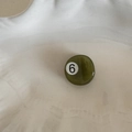 Close-up of olive green billiard ball hair clip with number 6 design on a tray - Round Style (FJ891721) / No.6 (Olive Green)