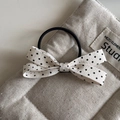 Detailed view of the woven fabric texture on a cream bow hair clip with black polka dots - White Polka Dot - Bow Hair Tie