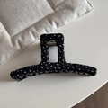 Detail view of a black and white polka dot fabric claw clip with strong metal spring - Black Polka Dot - Linear Claw