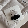 Detail view of handmade black and white polka dot fabric hair clips on display card - Black and White Pair - Oval Duckbill Clip