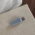 Detail view of a matte light blue hair clip with a silver duckbill metal clasp - Light Blue Solid No-Trace Clip
