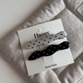 Close-up of black and white polka dot bow hair clips on a handmade gift card - Black and White Pair - Wave Duckbill Clip