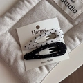 Close-up of black and white polka dot fabric bow hair clips on a white display card - Black and White Pair - Teardrop BB Clip