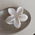 Detail of the elegant cream-white frangipani flower hair claw with marble texture - White Flower Marble