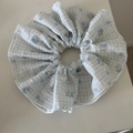 Detail of blue plaid scrunchie with floral cherry patterns on seersucker fabric - Blue Cherry Grid
