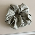 Detail shot of light grey checkered fabric scrunchie with soft folds and elegant texture - Scrunchie / Light Green
