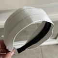Close-up of grey striped fabric headband with anti-slip inner teeth and linen texture - Headband / White